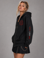 Side view of woman wearing black Buenos Aires Concert Zip Hoodie with sleeve graphic